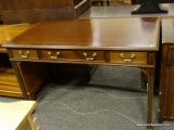 MAHOGANY 3 DRAWER DESK WITH BANDED TOP AND REEDED LEGS. 3 DRAWERS HAVE BRASS PULLS. MEASURES 48 IN X