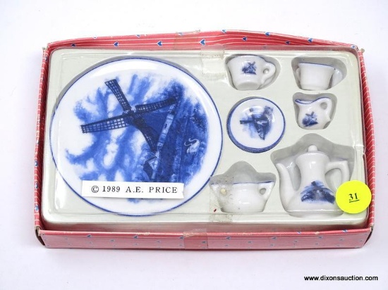 A.E. PRICE 1989 BLUE AND WHITE DELFT STYLE MINI TEA SET. IS IN CASE. ITEM IS SOLD AS IS WHERE IS