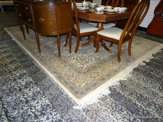 LARGE AREA RUG IN HUES OF CREAM, BLUE, AND PINK WITH A FLORAL BORDER AND CENTER. MEASURES 8 FT 11 IN