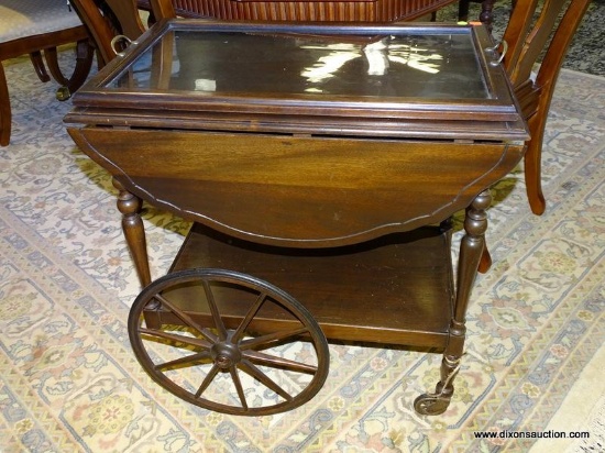 MAHOGANY ROLLING TEA CART WITH GLASS BUTLER SERVING TRAY, DROPSIDES, AND 1 LOWER SHELF. MEASURES 27