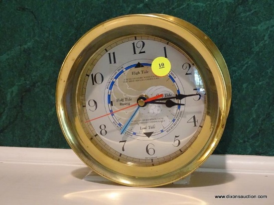 (LR) BRASS SHIPS CLOCK WITH HIGH AND LOW TIDE CLOCK BUILT INTO THE FACE. MEASURES 7" IN DIA. ITEM IS