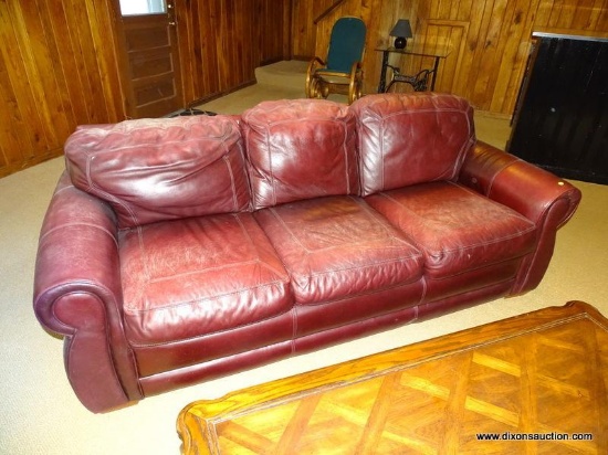 (DWN LR) RED LEATHER UPHOLSTERED 3 CUSHION SOFA WITH ROLLED ARMS AND REMOVABLE CUSHIONS. MEASURES 85