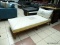 TEAK WOOD AND PEG CONSTRUCTED CHAISE LOUNGE WITH WHITE PILLOWS. MEASURES APPROXIMATELY 70 IN X 33 IN