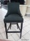 BRAND NEW GRAY UPHOLSTERED BAR CHAIR WITH SILVER TONE STUDDING AROUND THE EDGES. MEASURES 20 IN X 21