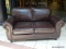 BRAND NEW MORTARA LEATHER LOVESEAT IN BROWN. A MODERN DESIGN COMBINED WITH LUXURIOUS, COMFORTABLE