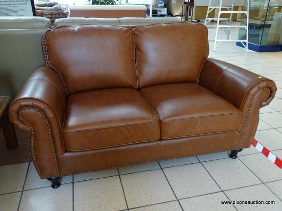 BRAND NEW ABBYSON TOP GRAIN LEATHER 2 CUSHION LOVESEAT WITH BRASS STUDDED ACCENTS AND ROLLED ARMS.