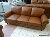 BRAND NEW ABBYSON TOP GRAIN LEATHER 3 CUSHION SOFA WITH BRASS STUDDED ACCENTS AND ROLLED ARMS.