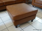 BRAND NEW ABBYSON TOP GRAIN LEATHER OTTOMAN WITH BRASS STUDDED ACCENTS AROUND THE EDGES. MEASURES 29