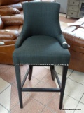 BRAND NEW GRAY UPHOLSTERED BAR CHAIR WITH SILVER TONE STUDDING AROUND THE EDGES. MEASURES 20 IN X 21