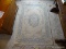 (BED1) CHINESE TUFTED RUG IN IVORY AND BLUE- 4 FT. X 6 FT., ITEM IS SOLD AS IS WHERE IS WITH NO