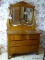(BED1) ANTIQUE OAK 2 OVER 2 CARVED DRESSER WITH BEVELED GLASS MIRROR, DRAWERS ARE DOVETAILED WITH