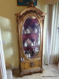(LR) GOLD GILT CURIO WITH APPLIED CARVED FLOWERS ON CREST AND DOOR COLUMNED SIDES WITH OVAL BEVELED