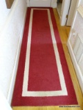 (BACK HALL) RED AND WHITE MACHINE MADE RUNNER- 3 FT. X 11 FT., ITEM IS SOLD AS IS WHERE IS WITH NO