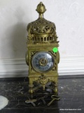 (FOYER) VINTAGE ORNATE BRASS CLOCK WITH 3 KEYS- 5 IN X 5IN X 14 IN ITEM IS SOLD AS IS WHERE IS WITH