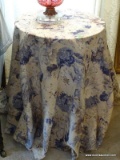 (LR) ROUND DECORATOR'S TABLE WITH TABLE CLOTH- 19 IN. DIA. X 25 IN H-ITEM IS SOLD AS IS WHERE IS