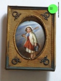 (LR) ANTIQUE PAINTING ON PORCELAIN OF LITTLE GIRL AT SEASHORE IN CLOTH AND BRASS FRAME- 4 IN X 5 IN