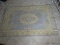(UPBED 1) TUFTED CHINESE RUG IN IVORY AND BLUE- 4 FT. X 6 FT., ITEM IS SOLD AS IS WHERE IS WITH NO