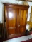 (FAM) CHERRY 2 DOOR ARMOIRE 55 IN X 24 IN X 72 IN, ITEM IS SOLD AS IS WHERE IS WITH NO GUARANTEES OR