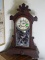 (FAM) ANTIQUE WALNUT GINGERBREAD MANTEL CLOCK WITH PAINTED GLASS OF BIRD- HAS PENDULUM AND KEY- 22
