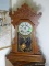 (FAM) ANTIQUE OAK WATERBURY GINGERBREAD CLOCK WITH KEY AND PENDULUM- 22 IN , ITEM IS SOLD AS IS