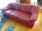 (KIT) RED LEATHER 3 CUSHION SOFA. MEASURES 77 IN X 36 IN X 31 IN. ITEM IS SOLD AS IS WHERE IS WITH