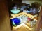 (KIT) CONTENTS OF CABINET TO INCLUDE A COLANDER, MEASURING CUPS, MIXING BOWLS, JARS, ETC. ITEM IS