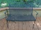 (OUT) CAST IRON AND MESHED WIRE PATIO BENCH. MEASURES 41 IN X 24 IN X 34 IN. ITEM IS SOLD AS IS