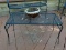 (OUT) CAST IRON AND MESHED WIRE PATIO COFFEE TABLE. MEASURES 34 IN X 17 IN X 16 IN. ITEM IS SOLD AS
