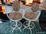 (KIT) PAIR OF ABSTRACT UPHOLSTERED AND WHITE METAL BAR CHAIRS WITH SWIVEL SEATS AND LOWER FOOTRESTS.