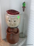 (SUN) 2 PIECE LOT TO INCLUDE AN ART POTTERY FIGURAL PLANTER, AND A EMPTY WINE BOTTLE WITH A GRAPE