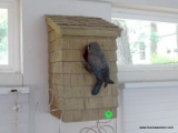 (SUN) HAND MADE WALL HANGING FIGURINE OF A BIRD GOING INTO A BIRDHOUSE. MEASURES 6 IN X 6 IN X 12