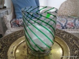 (SUN) CLEAR AND GREEN SWIRL PATTERN VASE WITH FOOTED BASE. MEASURES 8.5 IN X 12 IN. ITEM IS SOLD AS