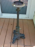 (OUT) CAST IRON CANDLE HOLDER WITH 3 LEGGED BASE. MEASURES 34 N TALL. ITEM IS SOLD AS IS WHERE IS