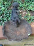 (OUT) CAST IRON BIRD BATH TOP IN THE FORM OF A CHERUB SITTING ATOP A SHELL. MEASURES 14 IN X 12 IN.