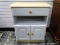 (R1) LIGHT WOOD FINISH AND WHITE PAINTED CABINET WITH 1 DRAWER OVER AN OPEN STORAGE AREA OVER 2