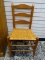 (R1) CHERRY MULE EARRED AND WOVEN SEAT SIDE CHAIR. MEASURES 18 IN X 17 IN X 36 IN. ITEM IS SOLD AS