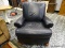 (R1) LEATHER UPHOLSTERED ARM CHAIR WITH MAHOGANY CARVED FEET. MEASURES 35 IN X 38 IN X 36 IN. ITEM