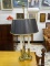 (R2) BRASS CANDLESTICK STYLE 3 LIGHT TABLE LAMP WITH BLACK SHADE. MEASURES 30 IN TALL. ITEM IS SOLD