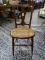 (R2) WALNUT VICTORIAN CANE SEAT SIDE CHAIR. MEASURES 17 IN X 16 IN X 34 IN. ITEM IS SOLD AS IS WHERE