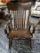 (R2) VINTAGE PINE ROCKING ARM CHAIR WITH ARROW BACK AND PLANK BOTTOM SEAT. MEASURES 24 IN X 31 IN X