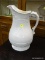 (R2) ANTIQUE WHITE CERAMIC WATER PITCHER. MEASURES 13 IN TALL. ITEM IS SOLD AS IS WHERE IS WITH NO