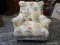 (R2) YELLOW UPHOLSTERED ARM CHAIR WITH POTTED FLOWER PATTERN. IS 1 OF A PAIR. MEASURES 32 IN X 34 IN