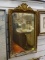 (R2) AGED GOLD TONE FRAMED MIRROR. MEASURES 14 IN X 23 IN. ITEM IS SOLD AS IS WHERE IS WITH NO