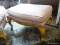 (R2) MAPLE QUEEN ANNE OTTOMAN WITH PINK AND WHITE DIAMOND UPHOLSTERY. MEASURES 32 IN X 22 IN X 21