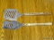 (R1) SET OF 2 BARBECUING SPATULAS WITH MADE IN SAWS (1 HAS A BUILT IN CHOPPER). ITEM IS SOLD AS IS,