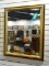 (R1) VINTAGE GOLD TONE AND BLACK FRAMED MIRROR WITH BEVELED GLASS EDGE. MEASURES 27 IN X 33 IN. ITEM