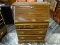 (R1) OAK FALL-FRONT DESK WITH 3 DRAWERS, BRASS TONE PULLS, AND INTERIOR CUBBY STORAGE. MEASURE 30 IN