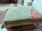 (R1) GEOMETRIC PATTERN QUILT IN HUES OF TURQOUISE, YELLOW AND WHITE. ITEM IS SOLD AS IS WHERE IS