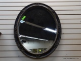 (R1) FRAMED MIRROR IN AN AGED BLACK FRAME. MEASURES 25 IN X 32 IN. ITEM IS SOLD AS IS WHERE IS WITH