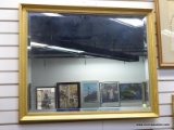 (R1) FRAMED AND BEVELED GLASS MIRROR IN A GOLD TONE FRAME. MEASURES 33 IN X 27 IN. ITEM IS SOLD AS